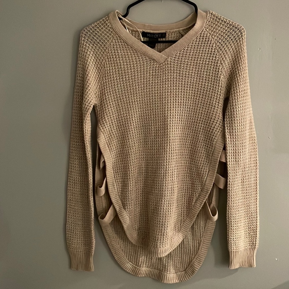 Tan knit sweater with three cut outs on the sides